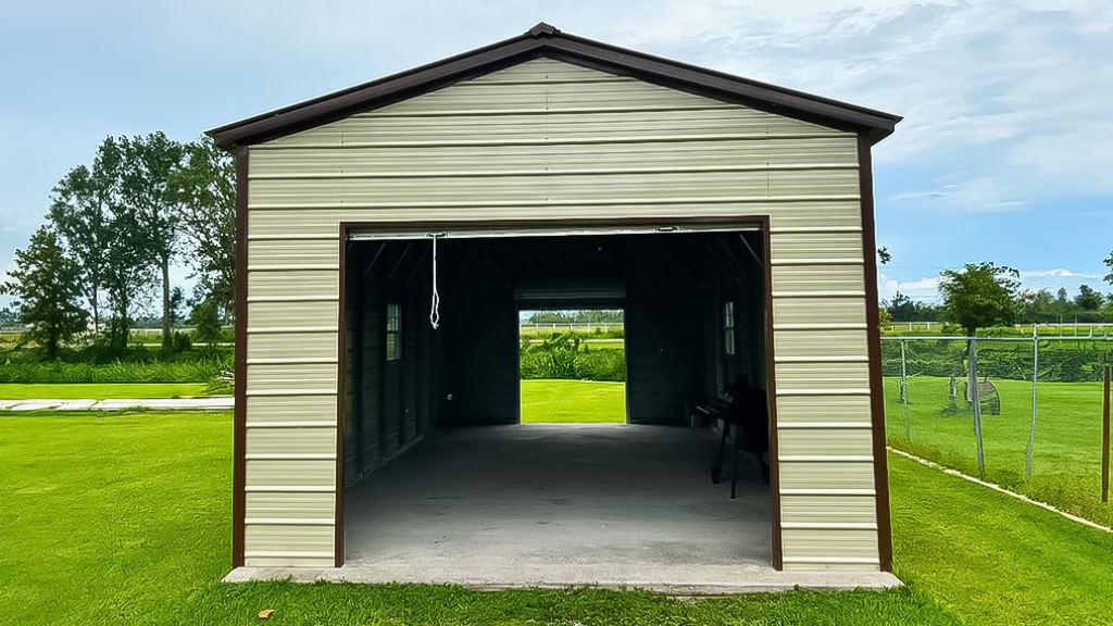 Tan metal garage with a roll-up door and a side door on a concrete slab.
