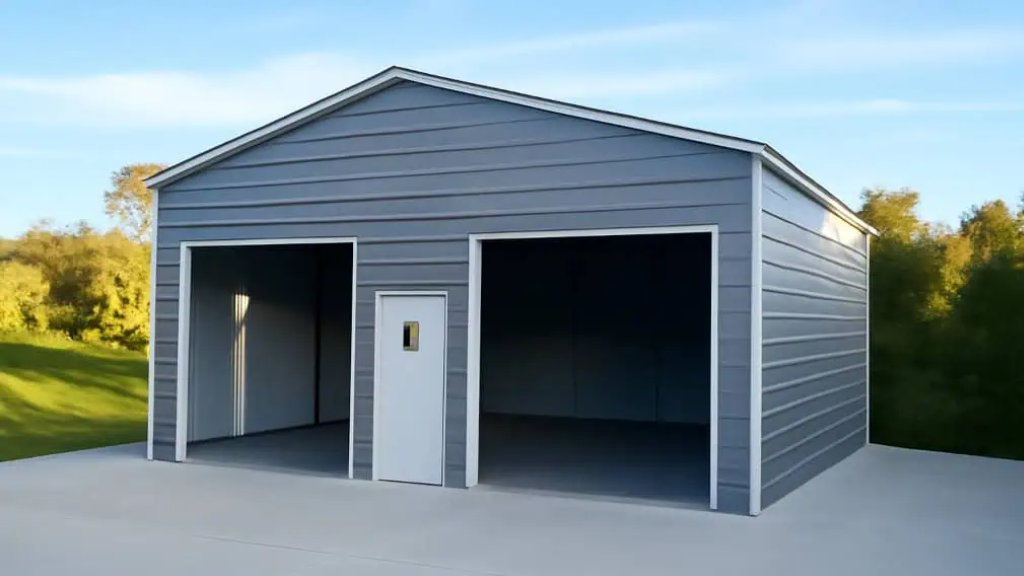 Three-bay metal garage with blue accents, gray walls, and white doors set on a concrete pad, in a grassy yard.