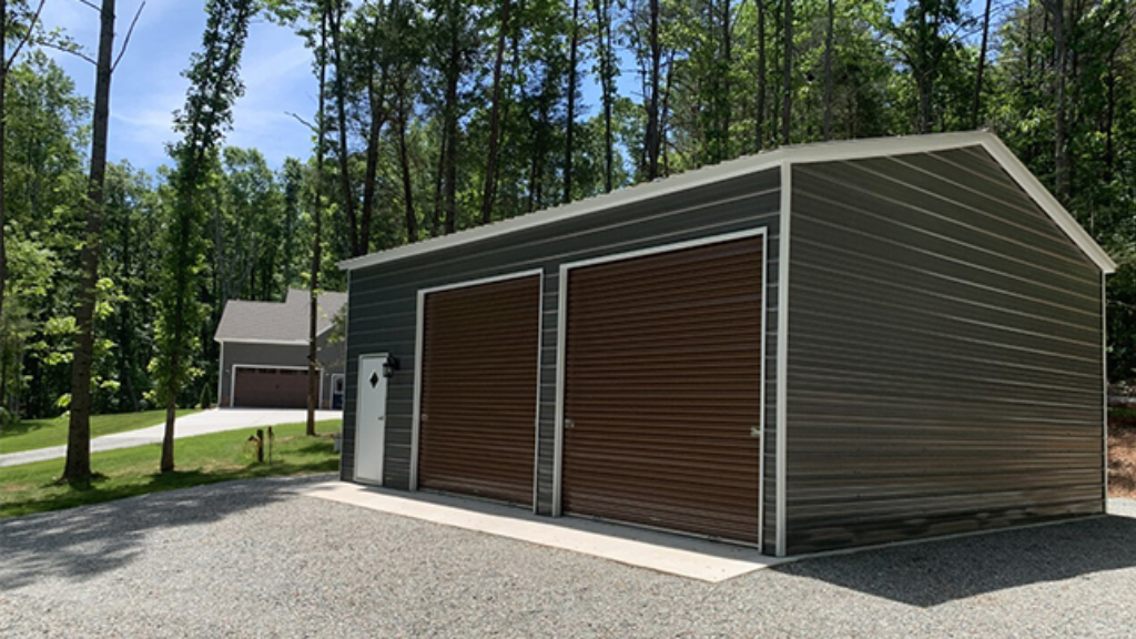 Tan metal garage with white door and open bay, set on grass.