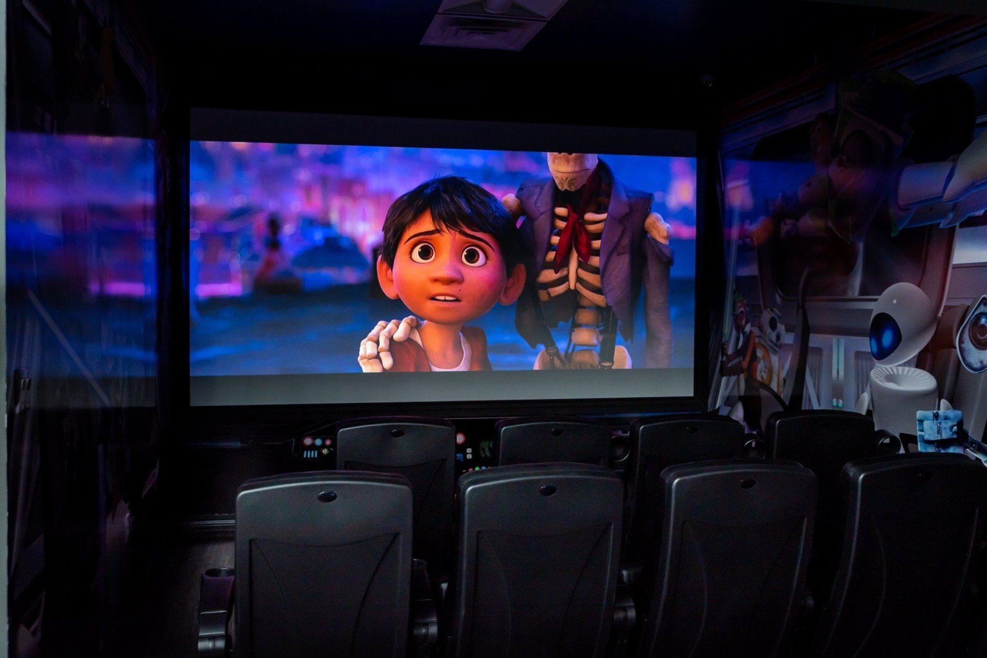 A movie is being shown on a large screen in a theater.