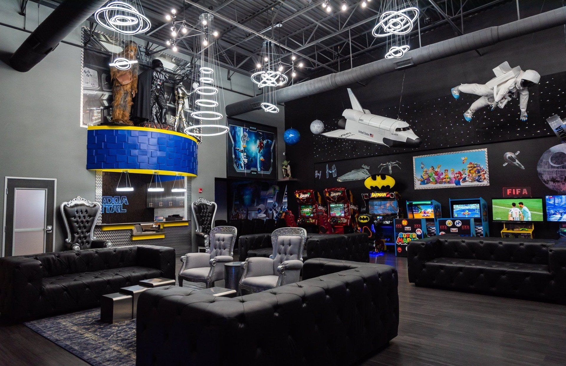 A large room with a lot of furniture and a lot of arcade games