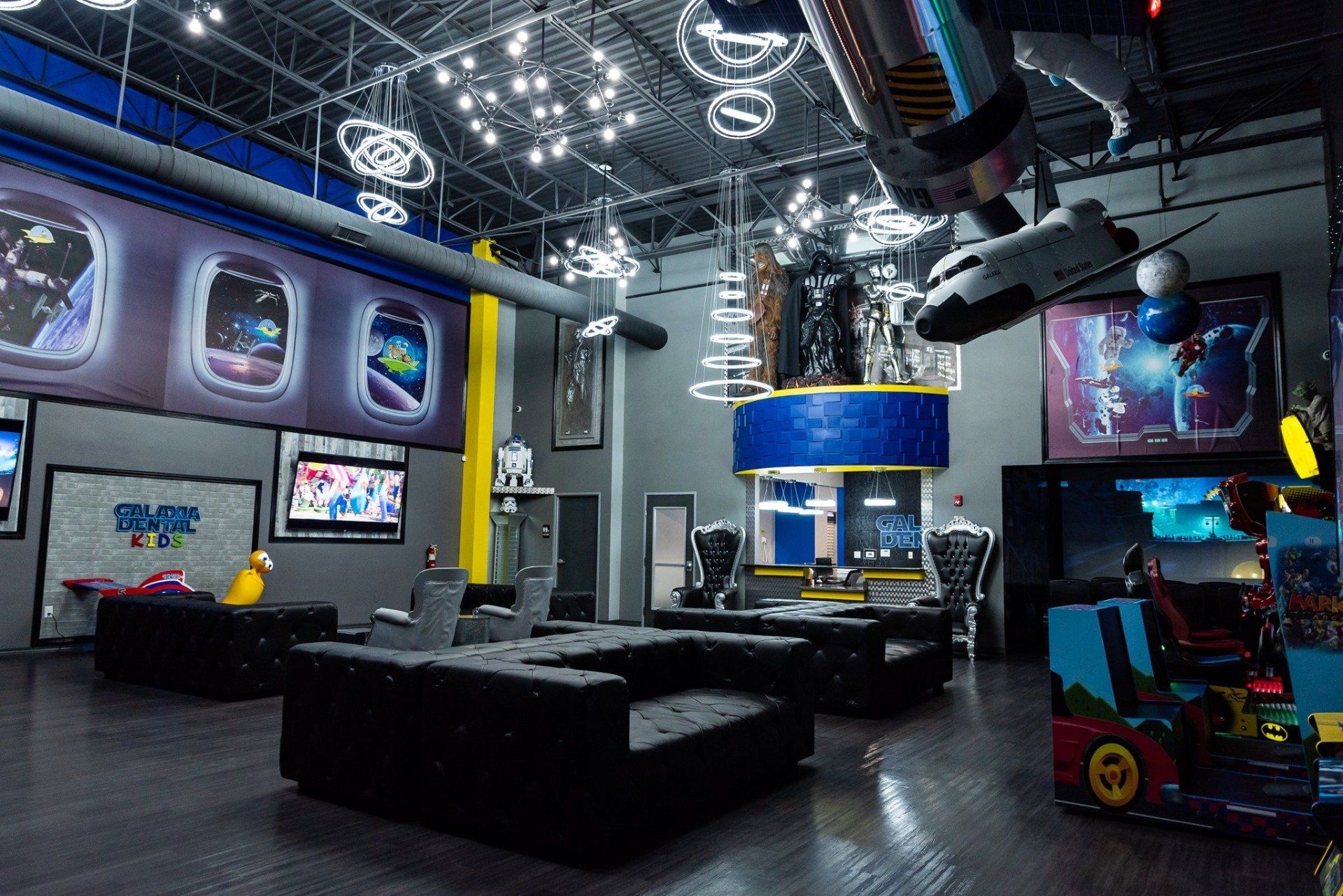 A large room with a lot of furniture and a lot of balloons hanging from the ceiling.