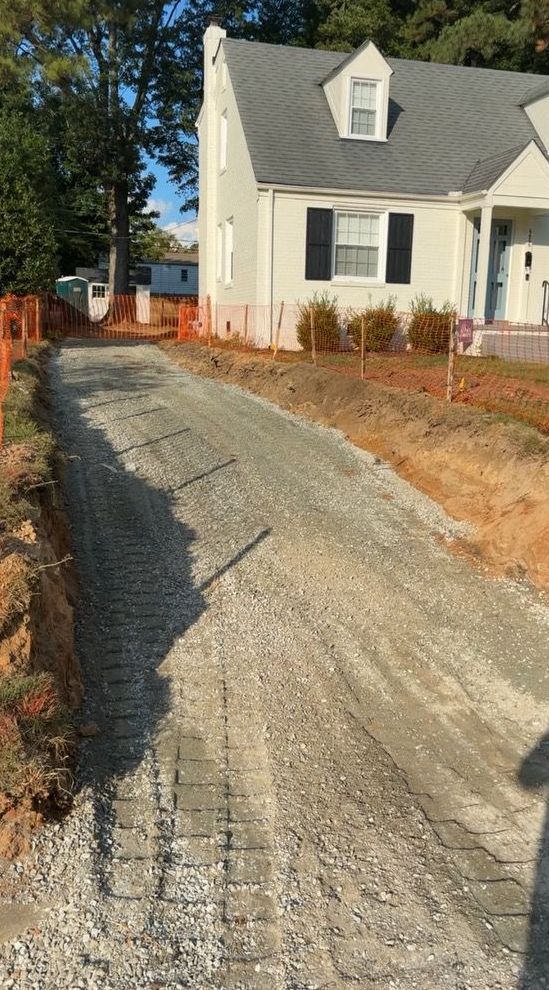 A driveway is being built in front of a house.