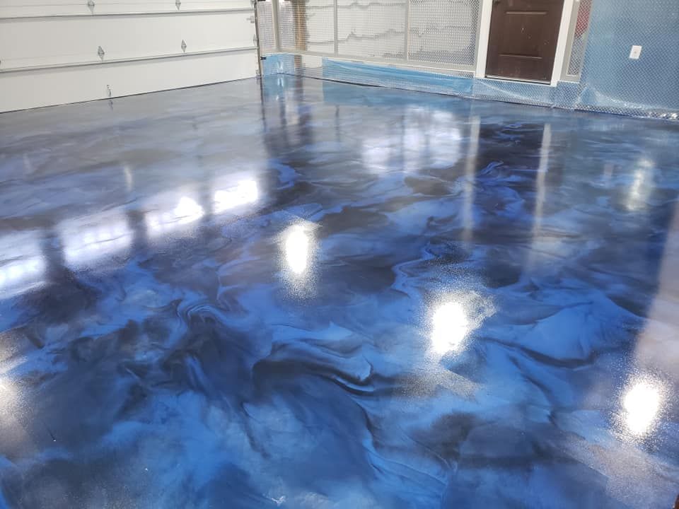 a blue and black metallic floor in a garage .