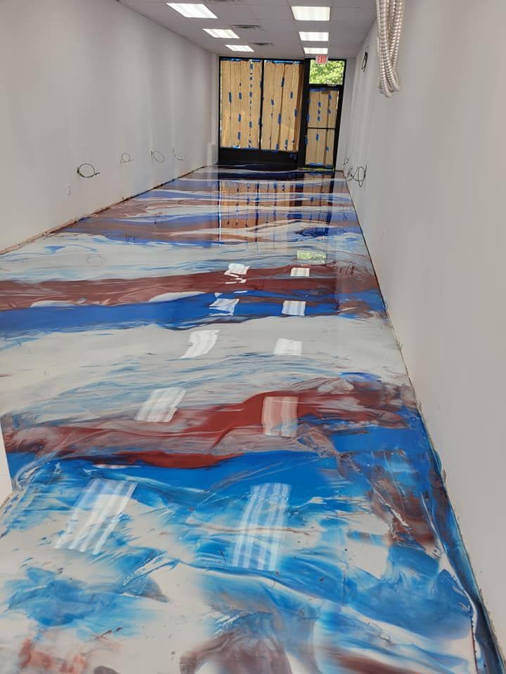 a long hallway with a painting on the floor .