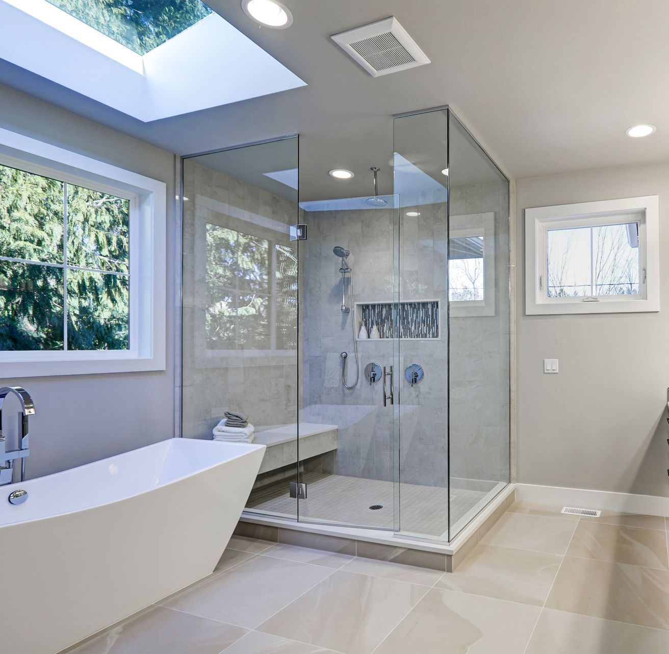 A bathroom with a tub and a walk in shower