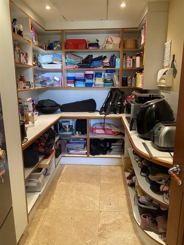 a Walk in Closet Filled With Clothes and a Laundry Basket — The Home Assembly In Avoca Beach, NSW