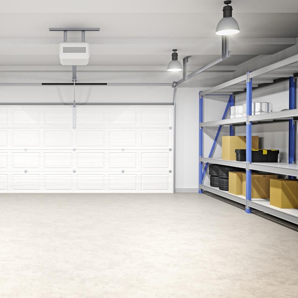 An empty garage with a garage door open and shelves filled with boxes. — The Home Assembly In Avoca Beach, NSW