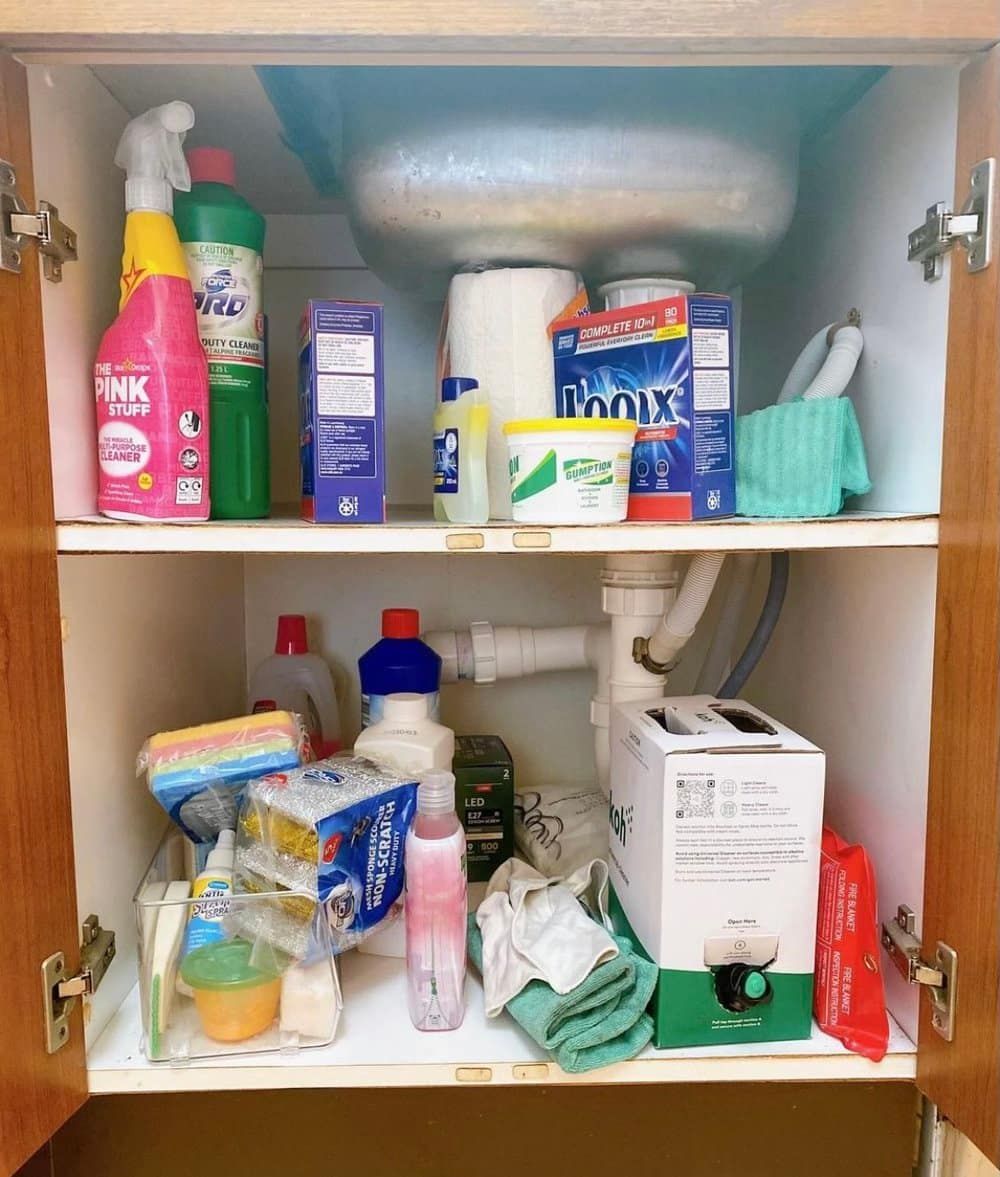 a Cabinet Filled With Cleaning Supplies Including a Box of Clorox — The Home Assembly In Avoca Beach, NSW
