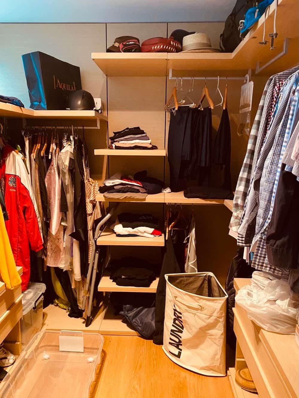 a Walk in Closet Filled With Clothes and a Laundry Basket — The Home Assembly In Avoca Beach, NSW