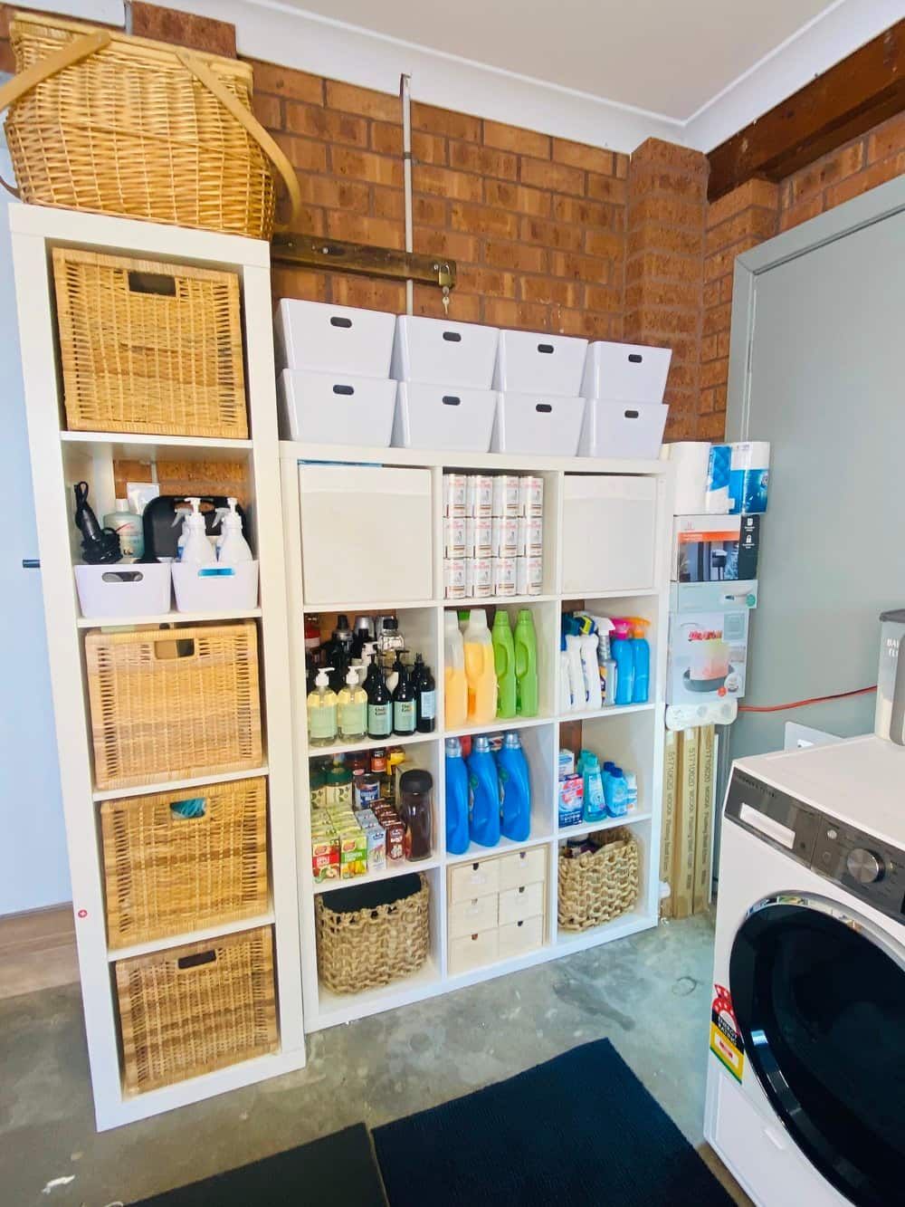 a Laundry Room With a Washer and Dryer and Lots of Baskets — The Home Assembly In Avoca Beach, NSW
