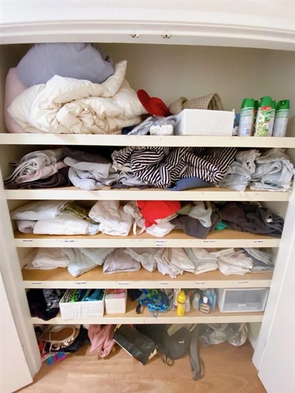 a Walk in Closet Filled With Clothes and a Laundry Basket — The Home Assembly In Avoca Beach, NSW