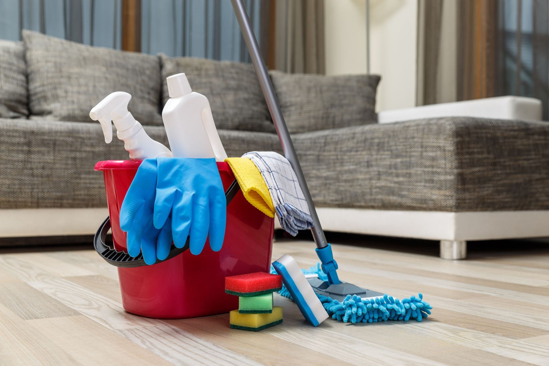 Cleaning service supplies: bucket with sponges, chemical bottles, mop, rubber gloves, and towel. Cleaning service supplies: bucket with sponges, chemical bottles, mop, rubber gloves, and towel.