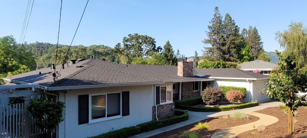 The image of a home in Walnut Creek, CA, being serviced by a roofing contractor