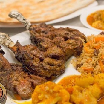 A plate of food with meat and rice on a table.