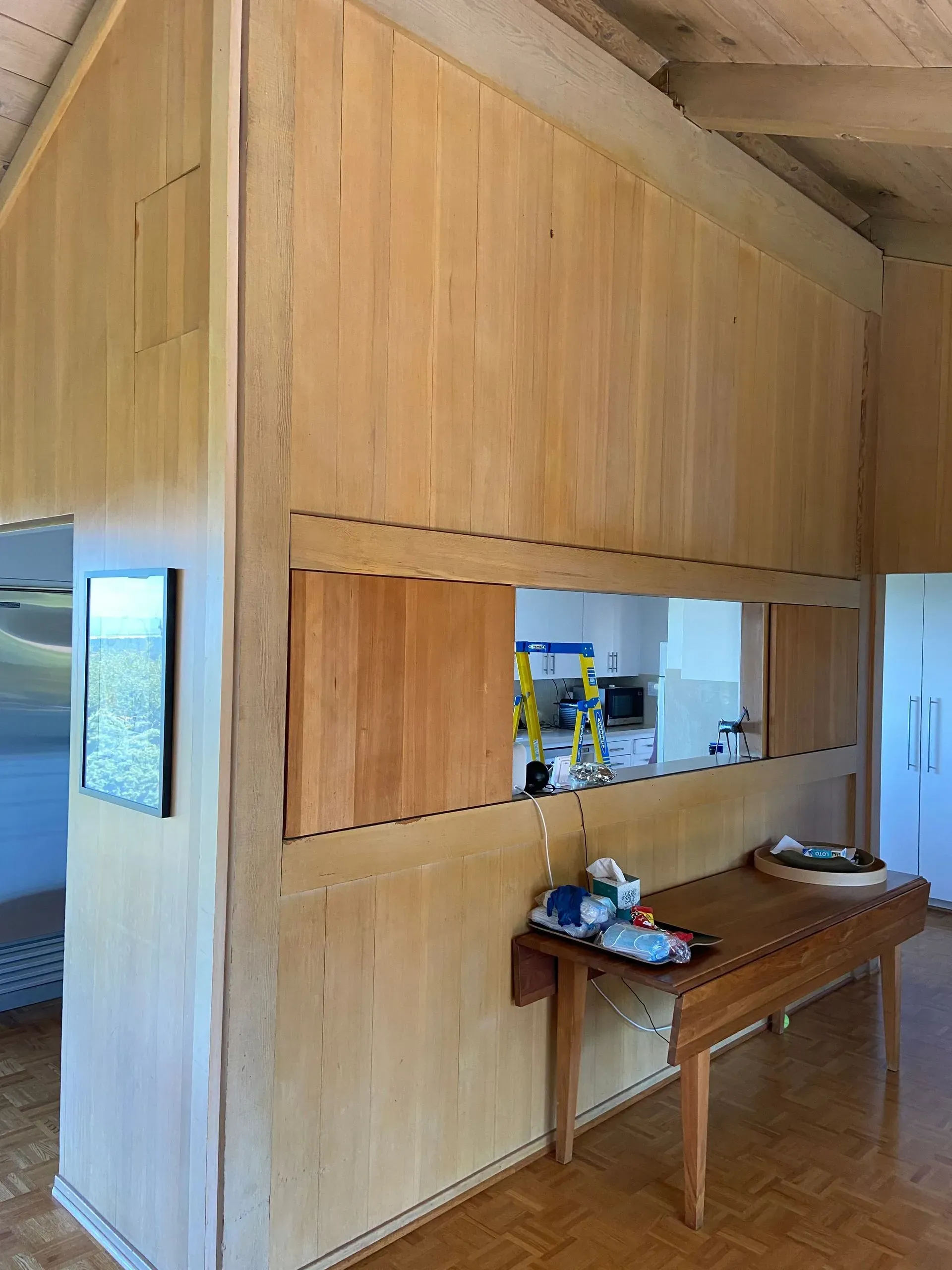 A room with wooden walls and a wooden table