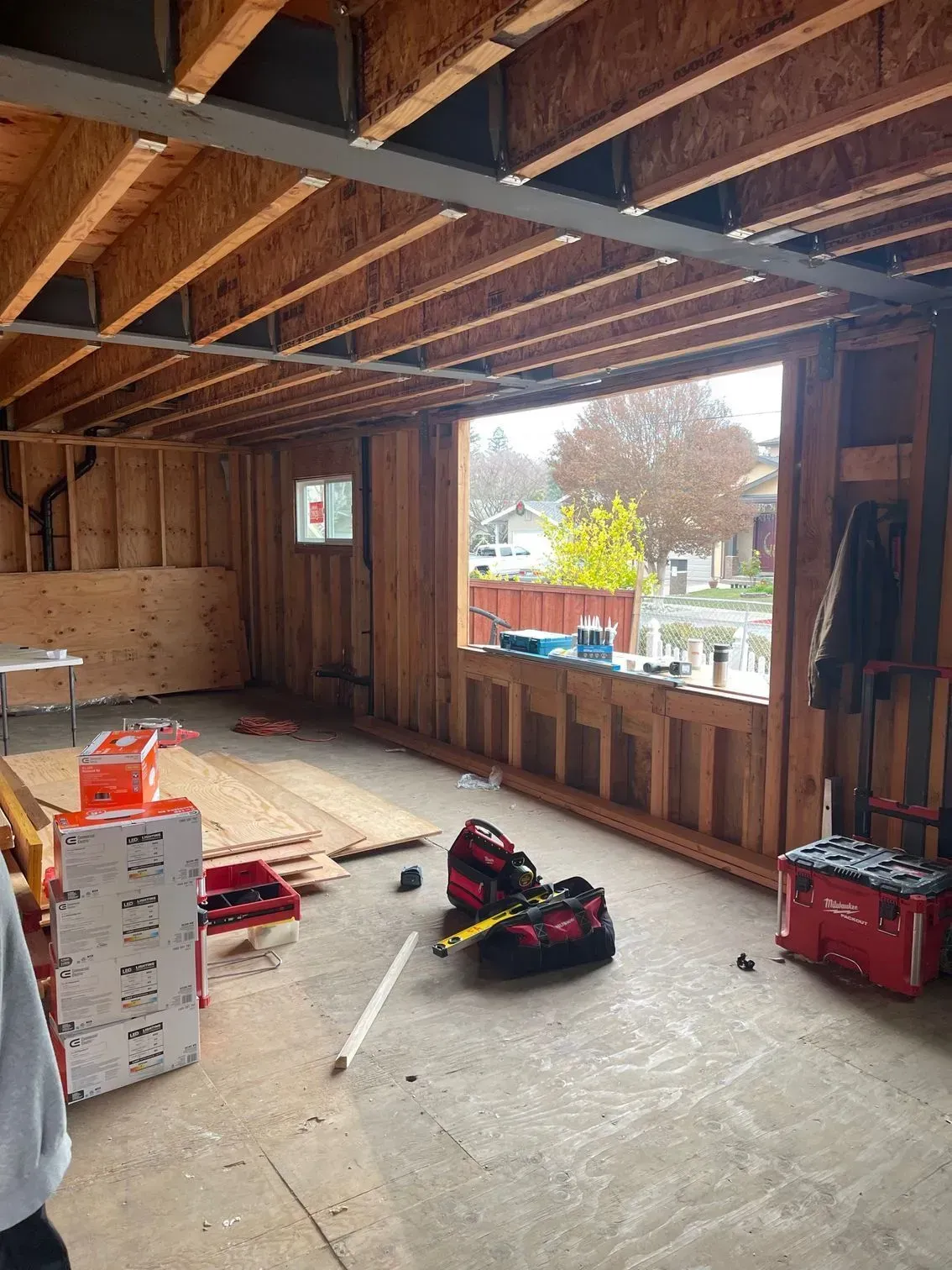 A room with a lot of wooden beams and a window.