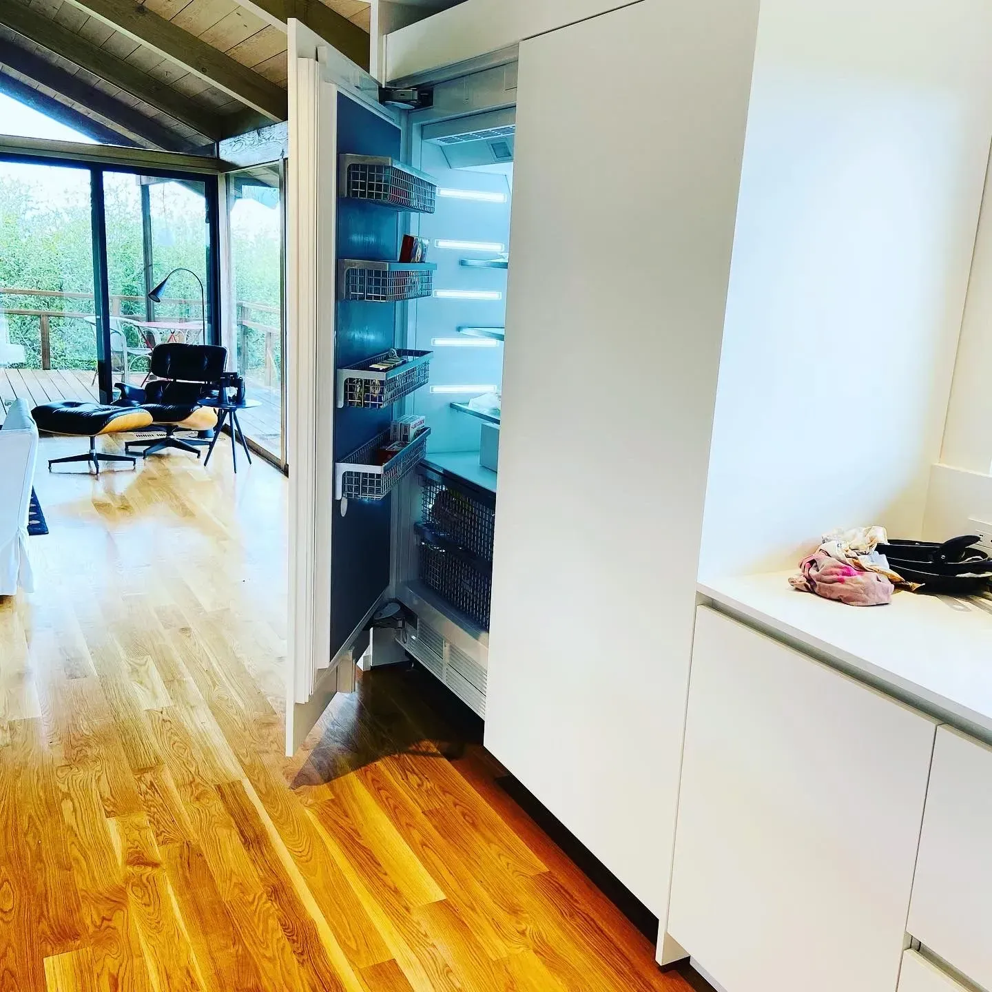 A kitchen with a refrigerator that has the door open