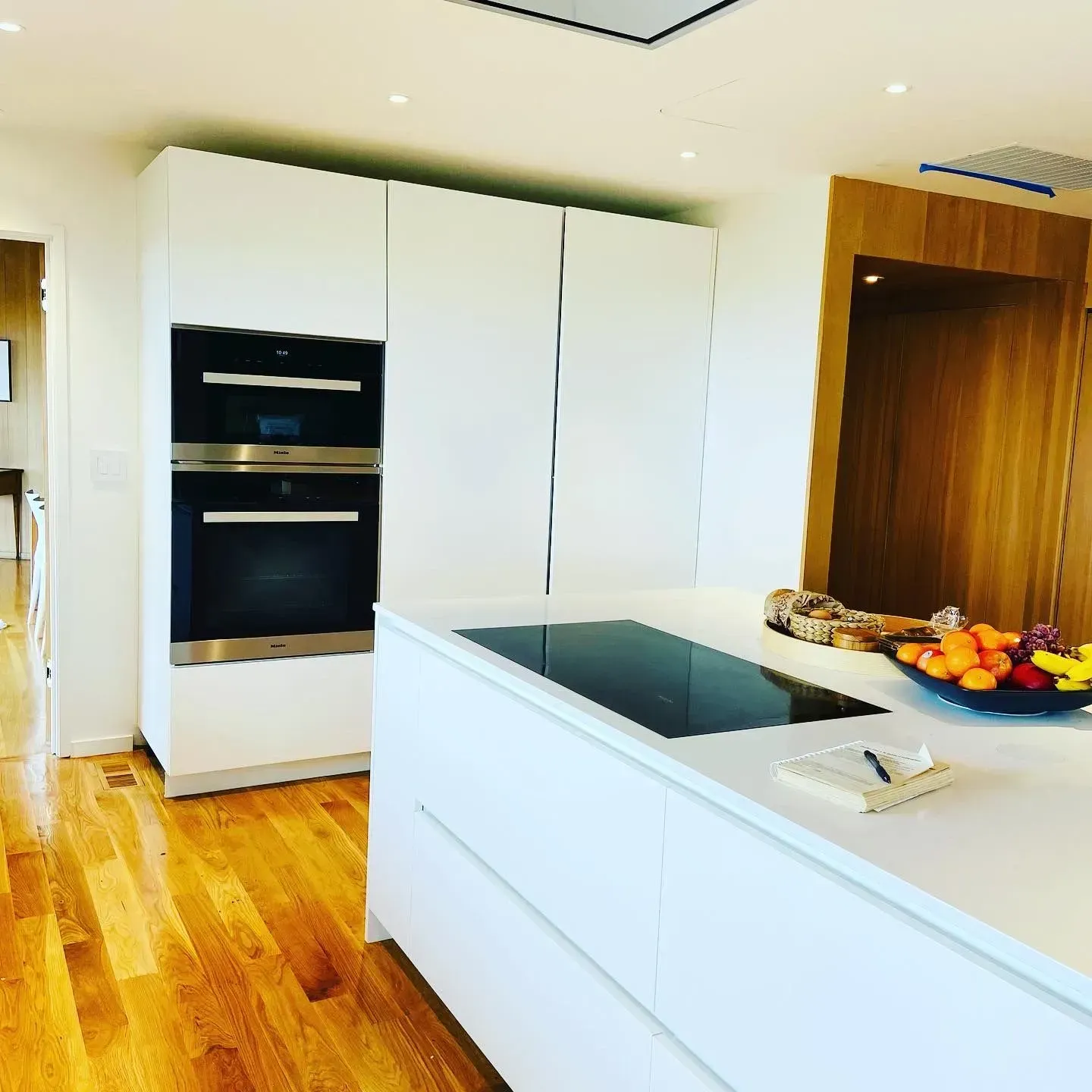A kitchen with white cabinets and a stove top oven