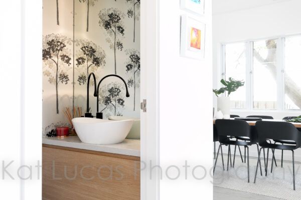 A Bathroom With a Sink and a Dining Room in the Background — Dowdy Constructions in Forster, NSW