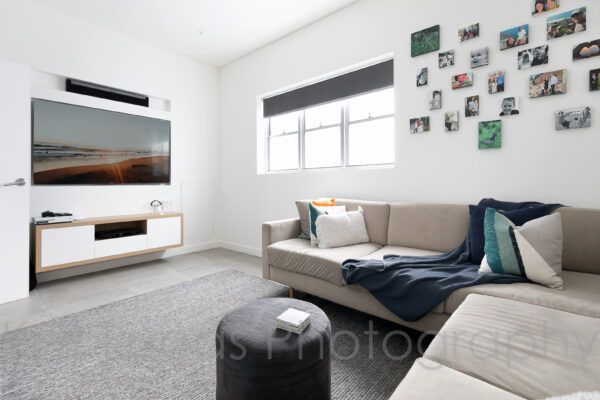 A Living Room With a Couch and a Flat Screen TV — Dowdy Constructions in Forster, NSW