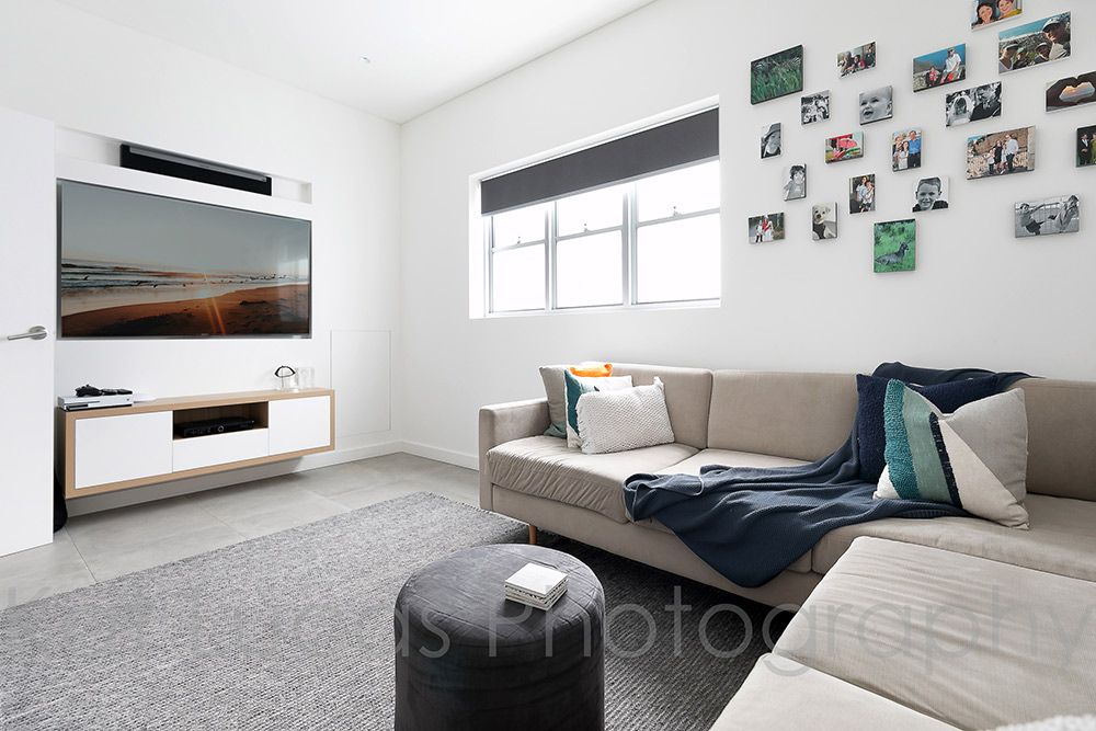 A Living Room With a Couch and a Flat Screen TV — Dowdy Constructions in Forster, NSW