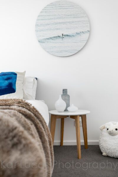 A Bedroom With a Painting on the Wall Above the Bed — Dowdy Constructions in Forster, NSW