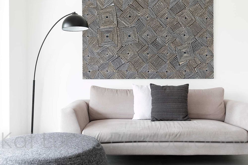 A Living Room With a Couch a Lamp and a Painting on the Wall — Dowdy Constructions in Forster, NSW