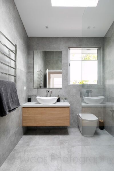 A Bathroom With Two Sinks and a Toilet — Dowdy Constructions in Forster, NSW