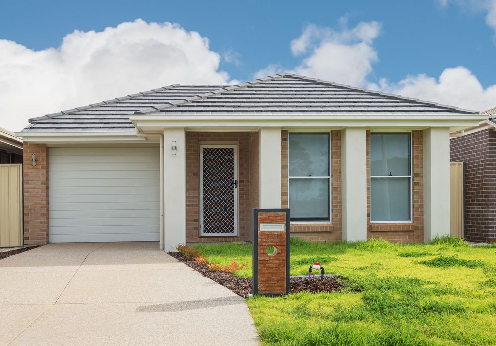The Front of a House With a White Garage Door — Dowdy Constructions in Tuncurry, NSW