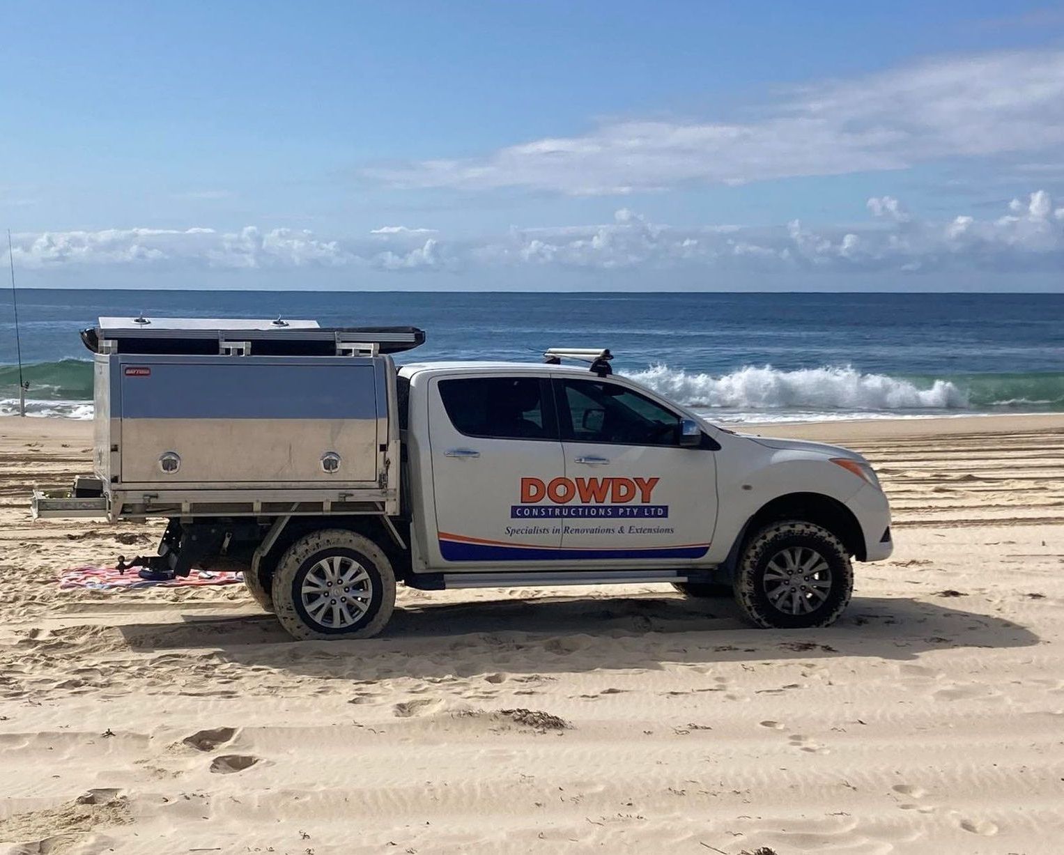 Business car driving on the beach — Dowdy Constructions in Forster, NSW