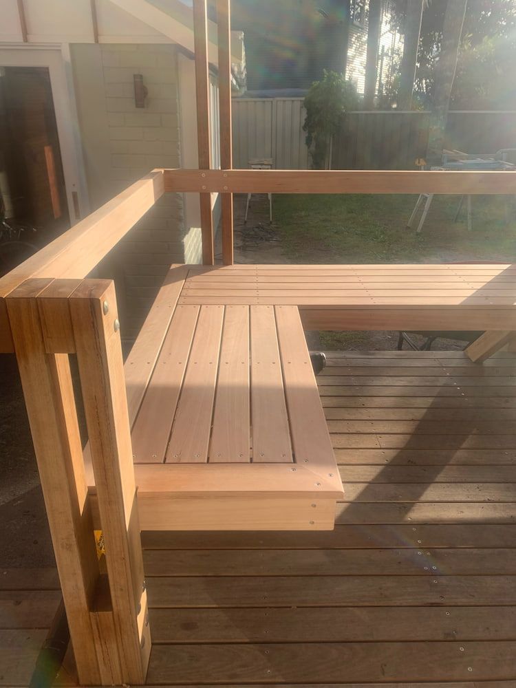 A Wooden Bench is Sitting on Top of a Wooden Deck — Dowdy Constructions in Smiths Lake, NSW