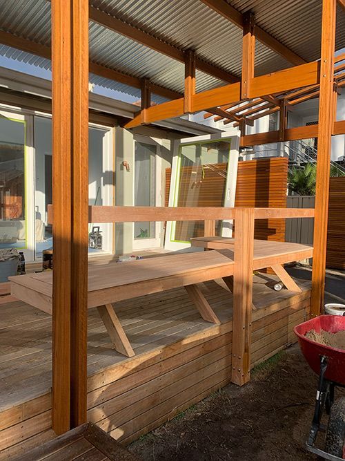 A Wooden Deck With a Picnic Table and a Wheelbarrow — Dowdy Constructions in Forster, NSW