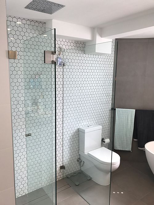 A Bathroom With a Toilet and a Walk in Shower — Dowdy Constructions in Forster, NSW