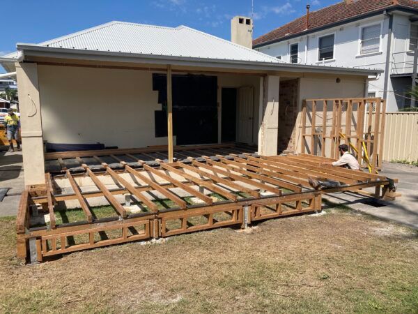 A Wooden Deck is Being Built in Front of a House — Dowdy Constructions in Forster, NSW