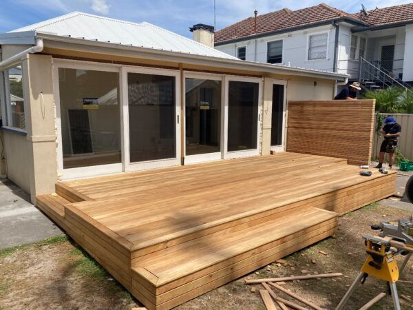 A Wooden Deck is Being Built in Front of a House — Dowdy Constructions in Forster, NSW