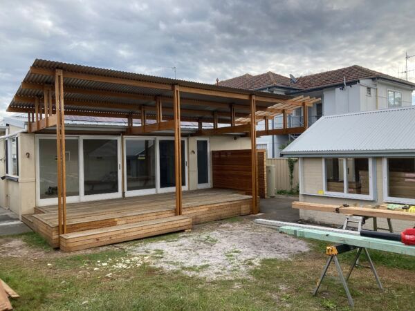 A House With a Wooden Deck is Being Built in the Backyard — Dowdy Constructions in Forster, NSW
