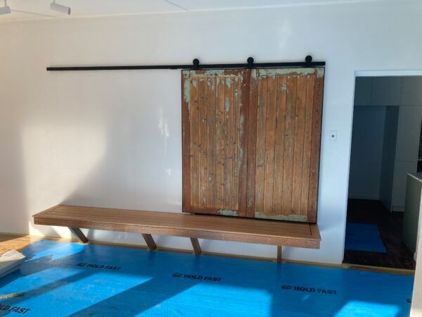 A Room With a Sliding Barn Door and a Wooden Bench — Dowdy Constructions in Forster, NSW