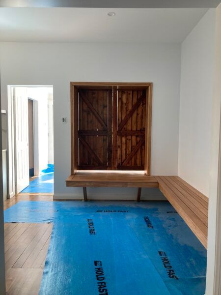 A Room With a Bench and a Window With a Blue Mat — Dowdy Constructions in Forster, NSW