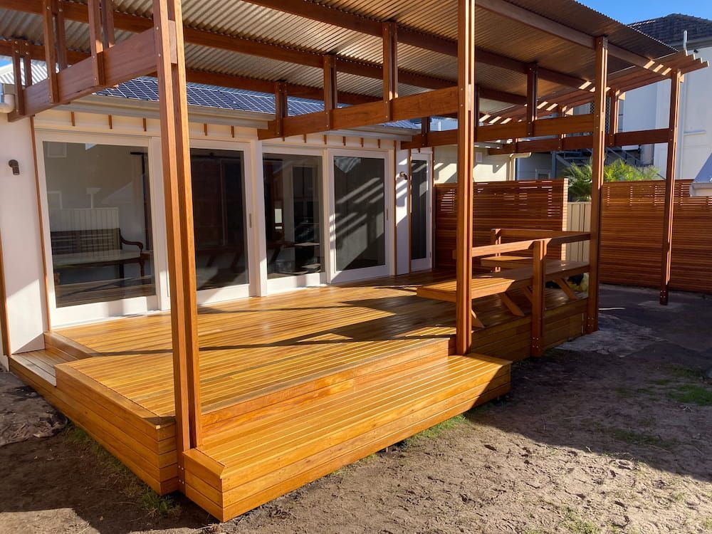 A House With a Wooden Deck in Front of It — Dowdy Constructions in Forster, NSW