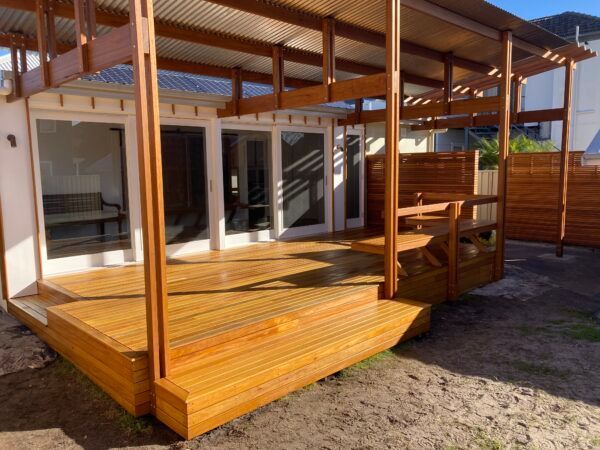A House With a Wooden Deck in Front of It — Dowdy Constructions in Forster, NSW