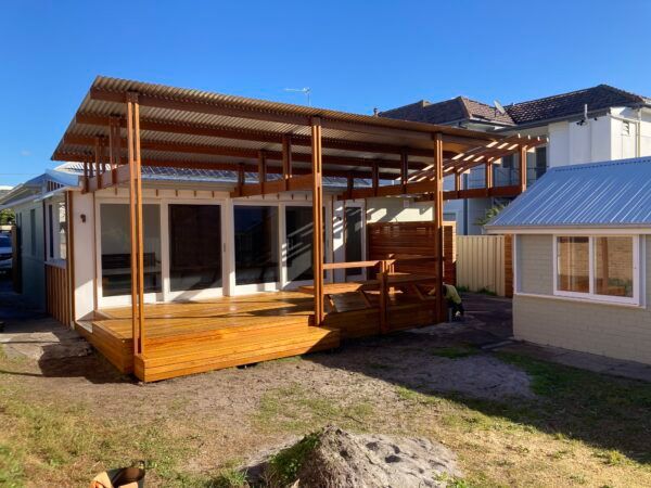 A House With a Wooden Deck in Front of It — Dowdy Constructions in Forster, NSW