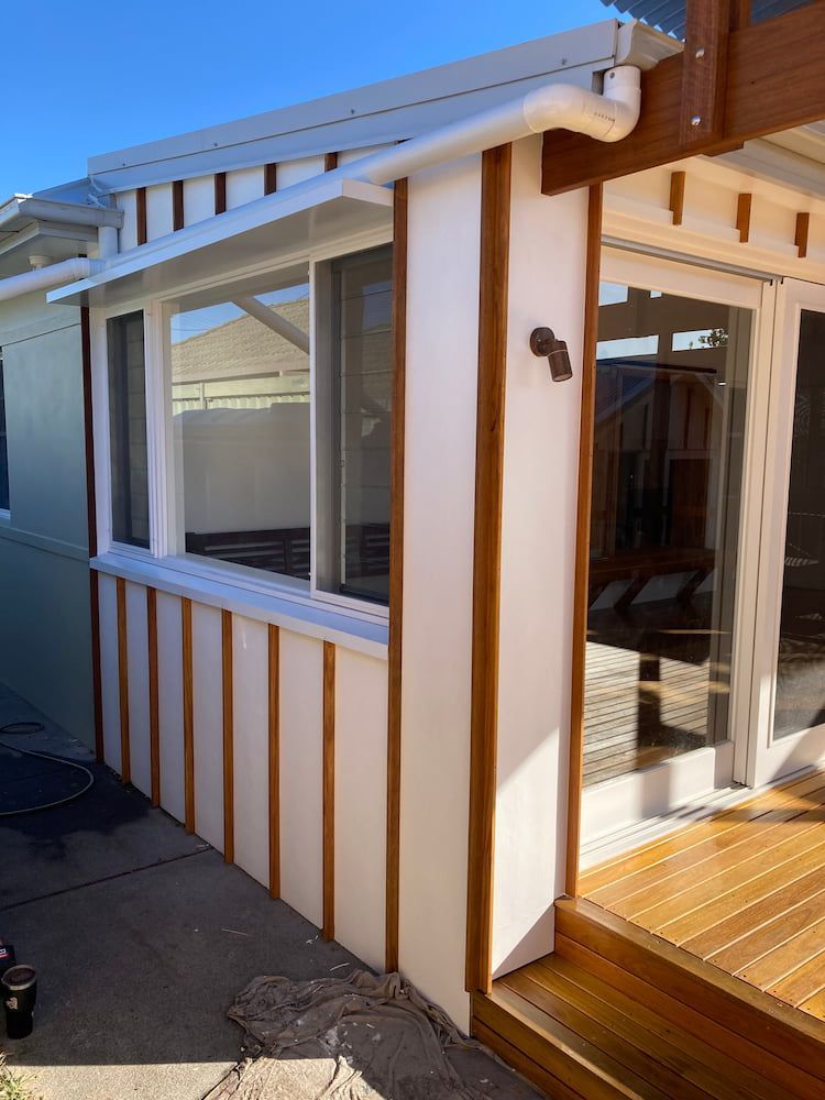 A House With a Lot of Windows and a Wooden Deck — Dowdy Constructions in Forster, NSW