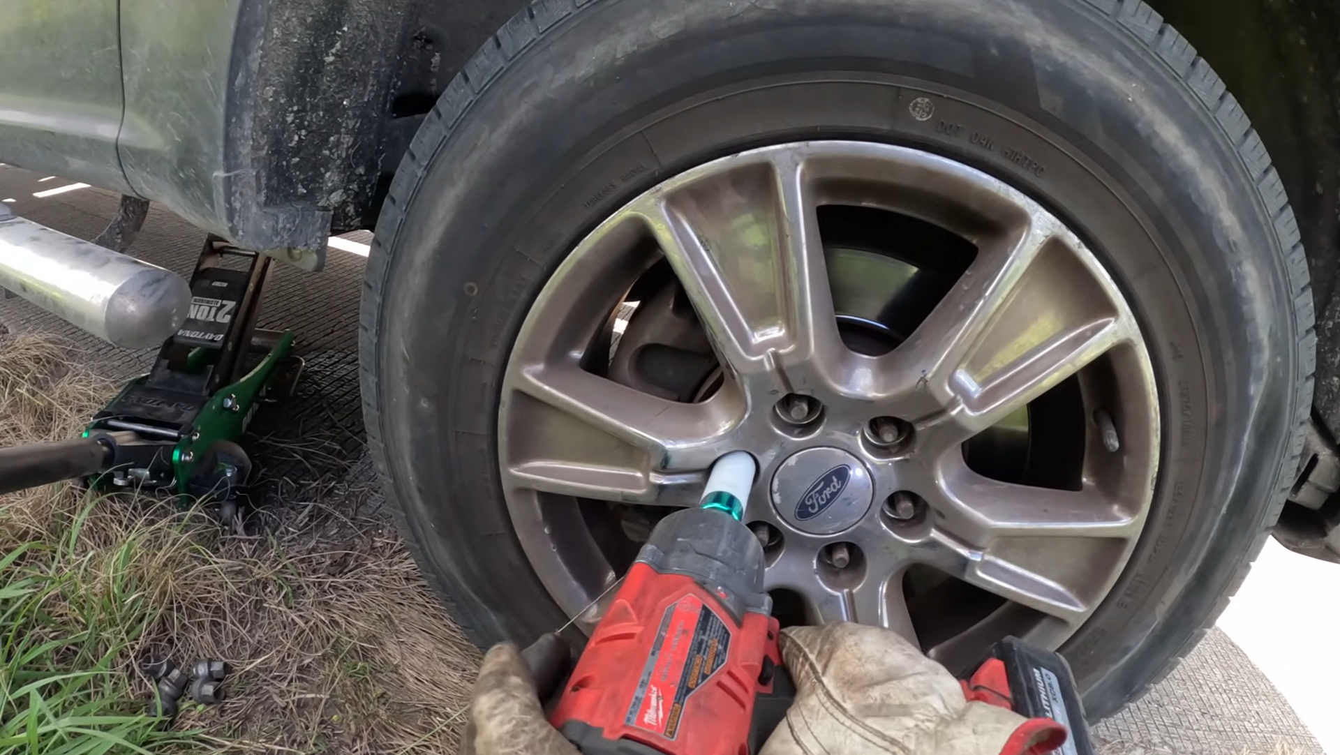 Crew taking off a flat tire