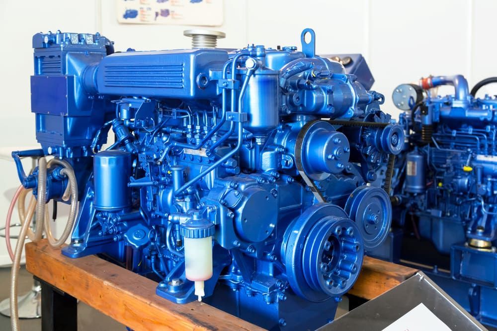 A Blue Engine is Sitting on Top of a Wooden Table — Whitsunday Diesel & Marine In Airlie Beach, QLD