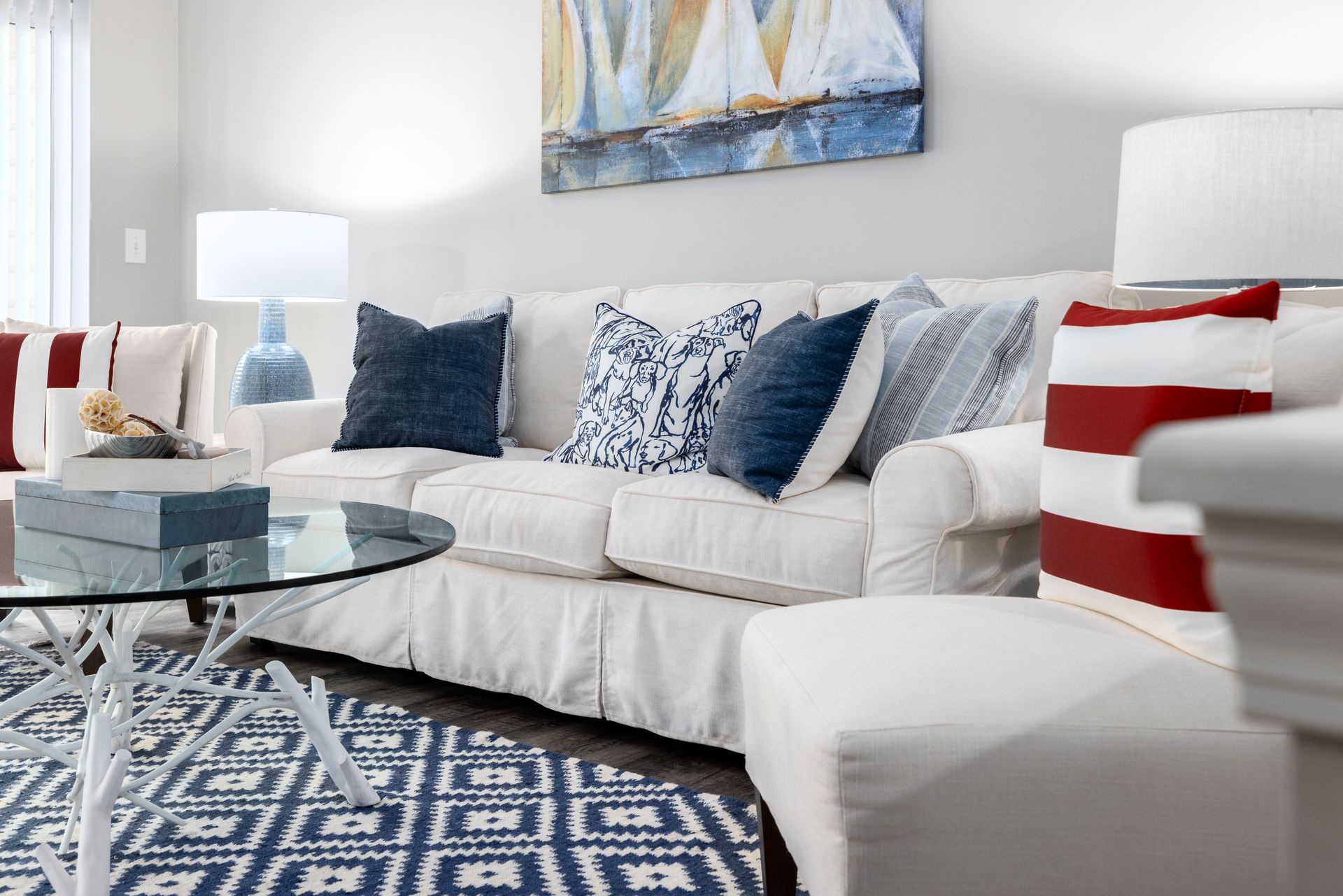 A living room with a white couch , chairs , and a glass coffee table | The Grove at Oakbrook