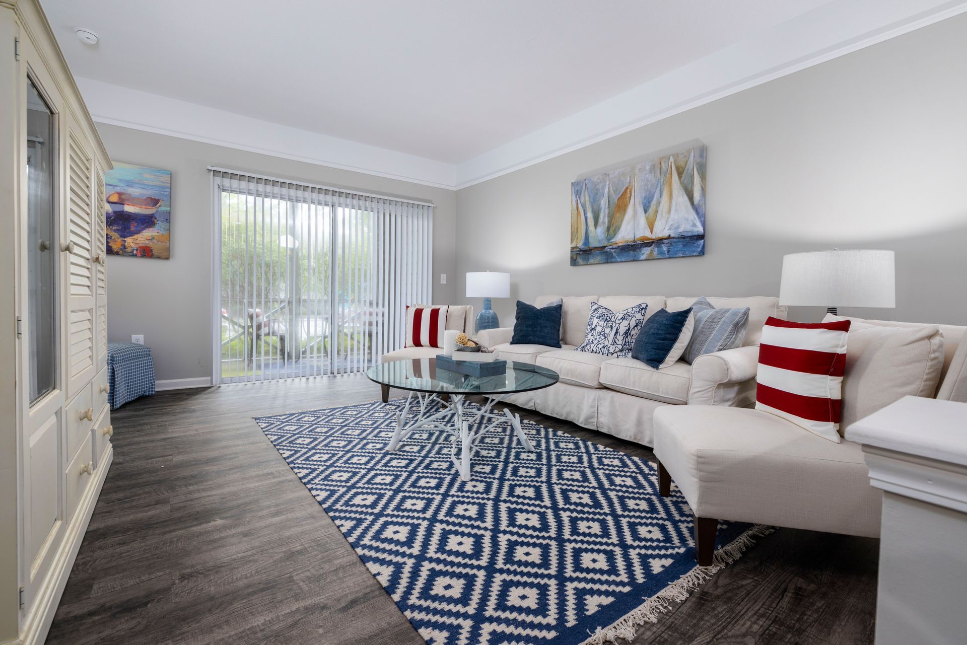 A living room with a couch , chair , coffee table and rug | The Grove at Oakbrook