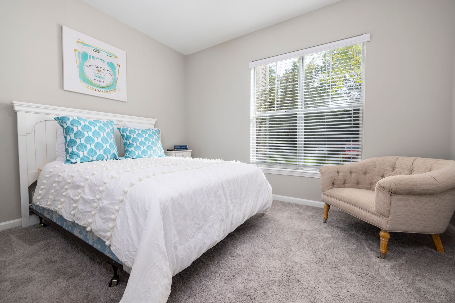 A bedroom with a bed , chair , and window | The Grove at Oakbrook