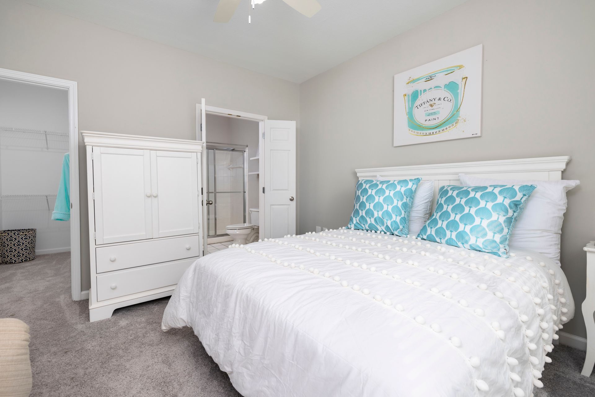 A bedroom with a bed , dresser , nightstand , and ceiling fan | The Grove at Oakbrook