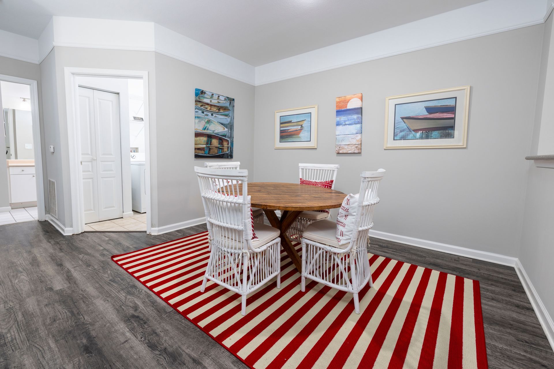 A dining room with a table and chairs and a striped rug | The Grove at Oakbrook